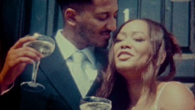 A couple sharing a glass of champagne on their wedding day